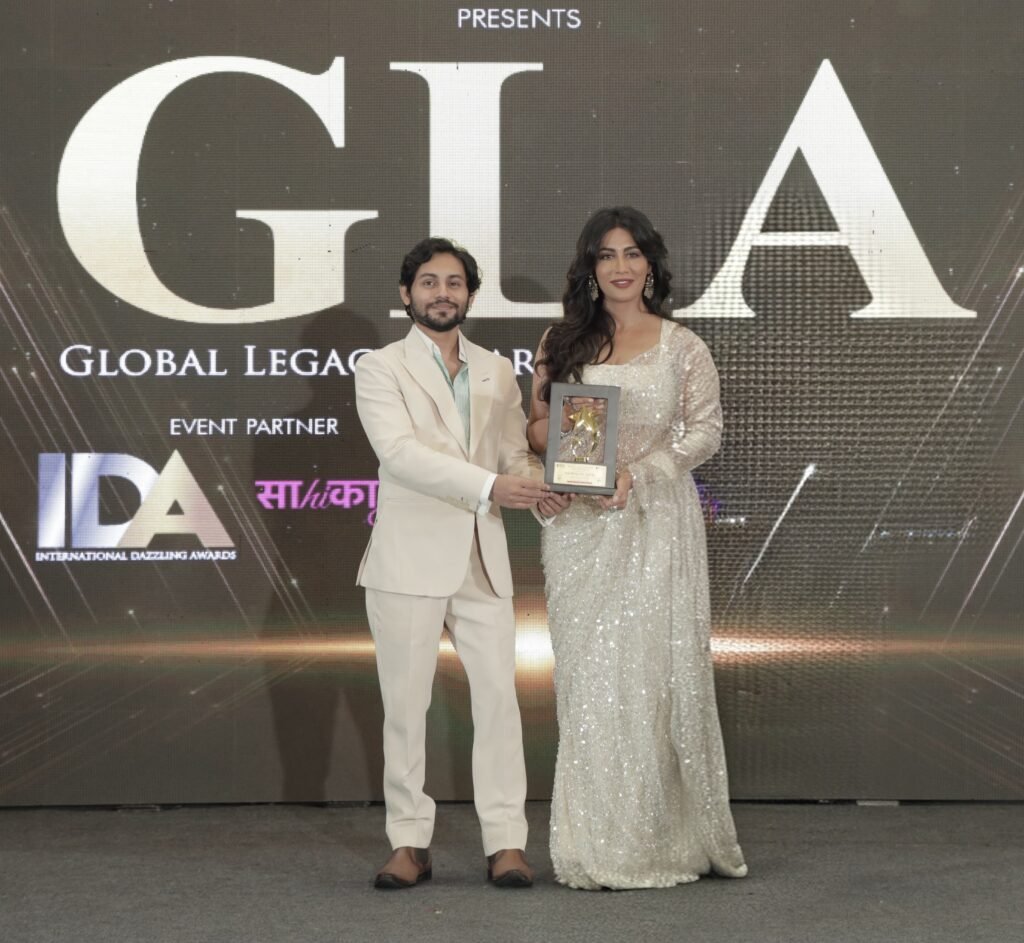 Kumar Shivam receiving the Global Excellence Award 2026 on behalf of Higher Education Centre and Trula Overseas from Bollywood actress Chitrangada Singh at an award ceremony.